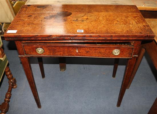 A George III oak tea table with folding top W.77cm